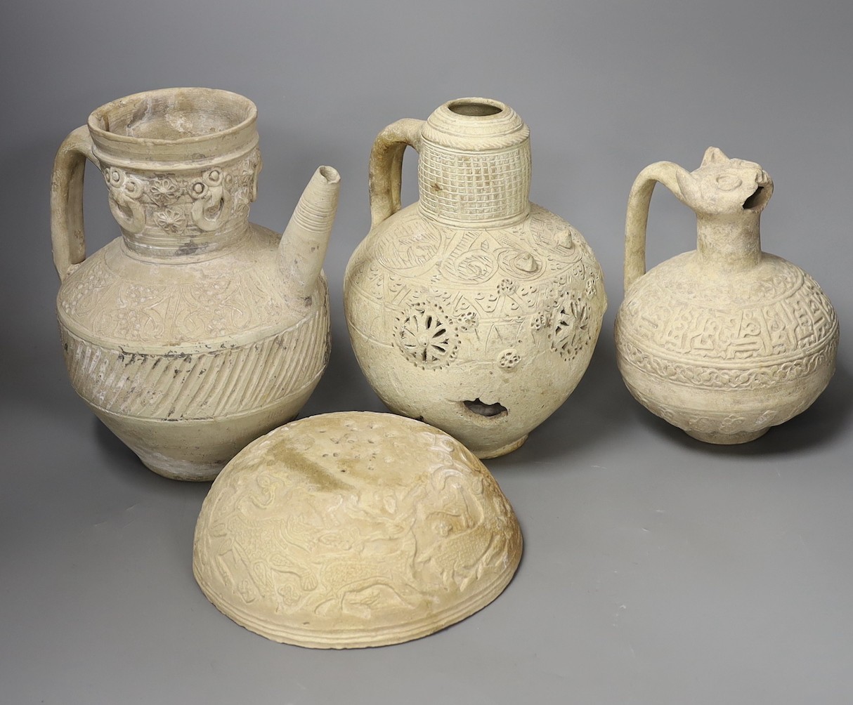 Three Islamic terracotta jugs and a strainer, Middle Eastern, possibly 12th century, tallest 24cm